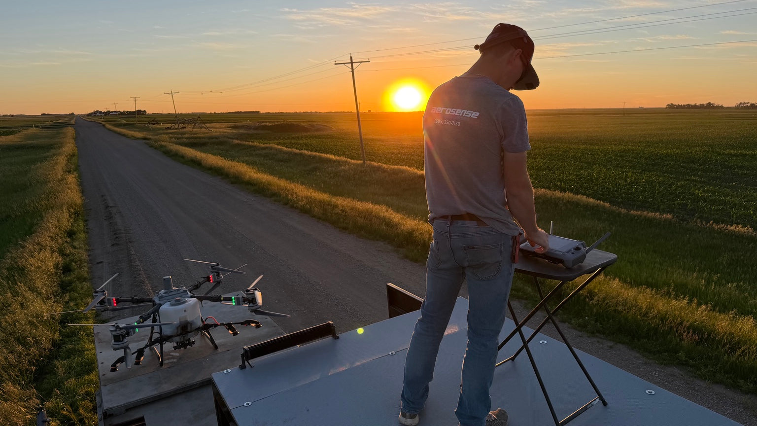 TJ Aerosense agricultural spray drone operation at sunset in South Dakota